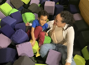 child plays in foam pit